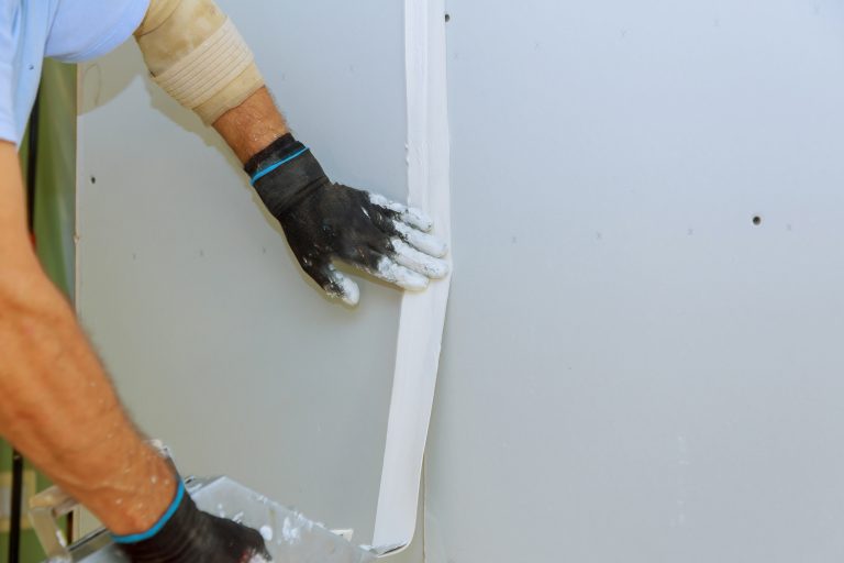 taping new drywall seam with mud